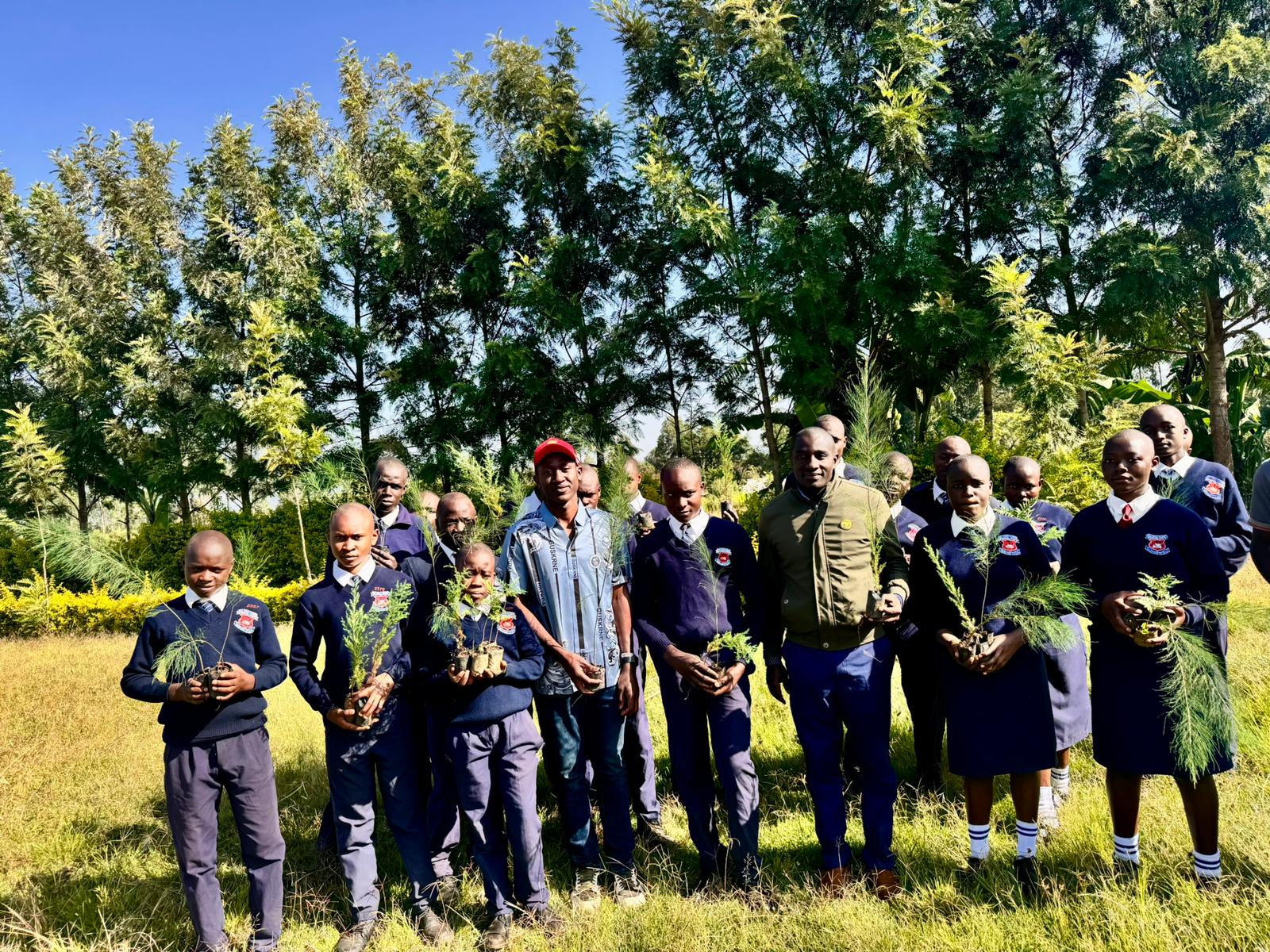 Students and community members participating in tree planting ceremony at Utando Kenya project